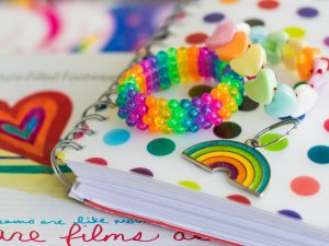 Rainbow notebook, bracelets, and keychain.