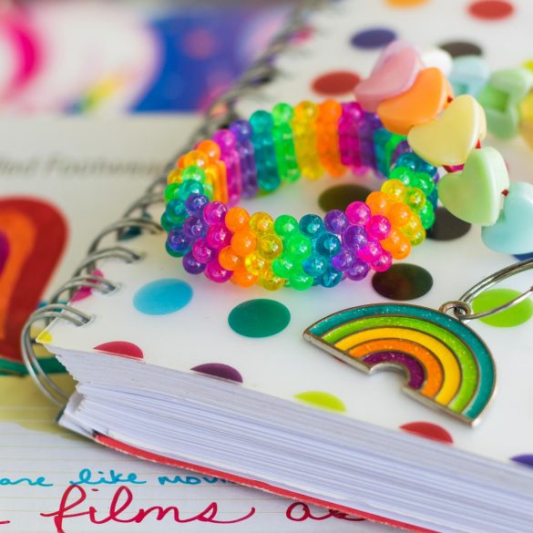 Rainbow notebook, bracelets, and keychain.