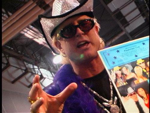 An intense man yelling at the camera at AVN, while wearing a sparkly cowboy hat.