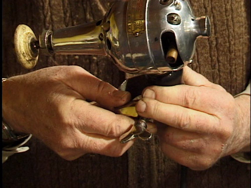 A vintage clamp that could attach a vibrator to a rocking chair.