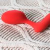 Aneros Evi kegel exerciser on top of a cream-colored knit fabric.