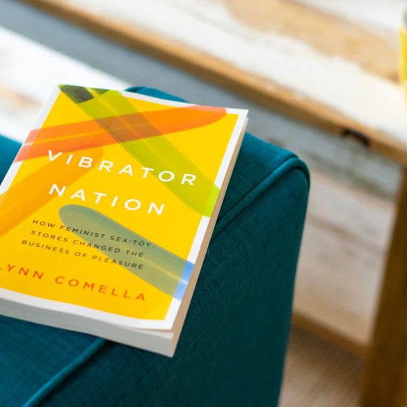Vibrator Nation: How Feminist Sex-Toy Stores Changed the Business of Pleasure by Lynn Comella, on the arm of a couch, with coffee nearby.
