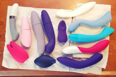 From above shot of a bunch of vibrators lying on paper towels on my desk.