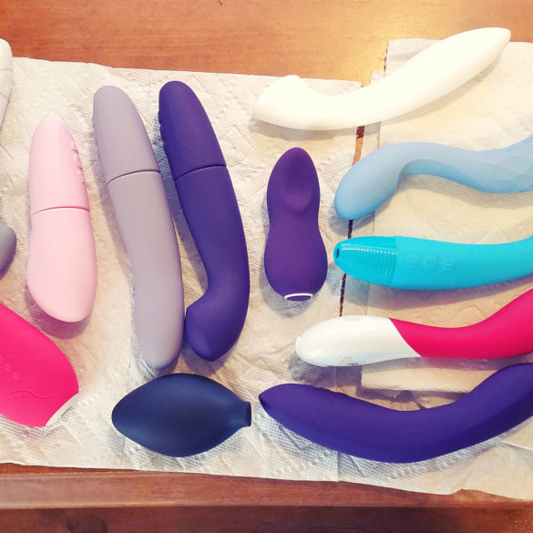 From above shot of a bunch of vibrators lying on paper towels on my desk.