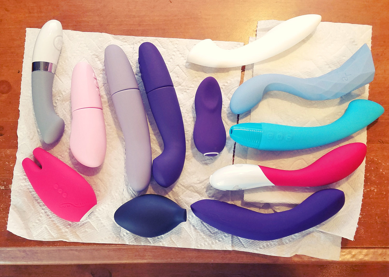 From above shot of a bunch of vibrators lying on paper towels on my desk.