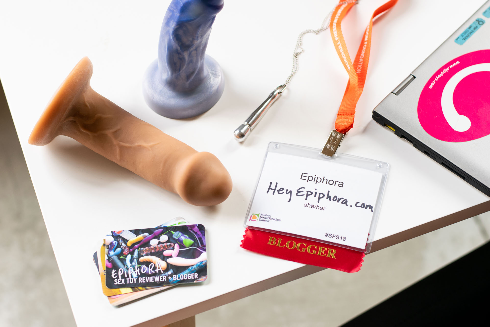 Sex blogger business cards, a conference badge, a Doxy necklace, and two amazing dildos: Buck and Splendid.