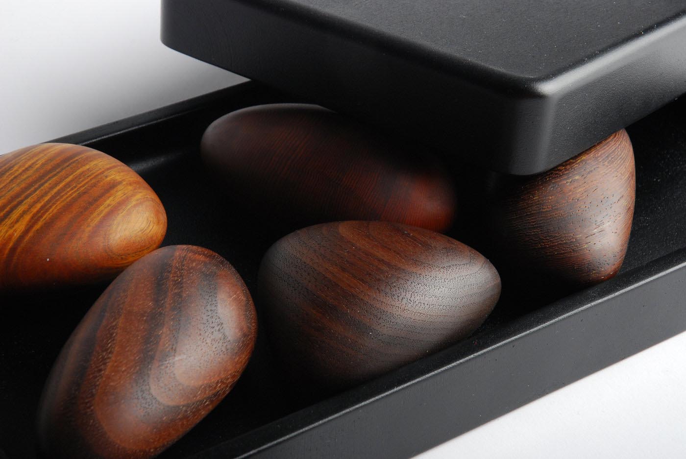 A box of pebble-shaped wooden objects.