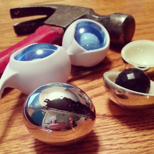 Chipping silver paint and broken open OVO L1 Silicone Love Balls. With a hammer.