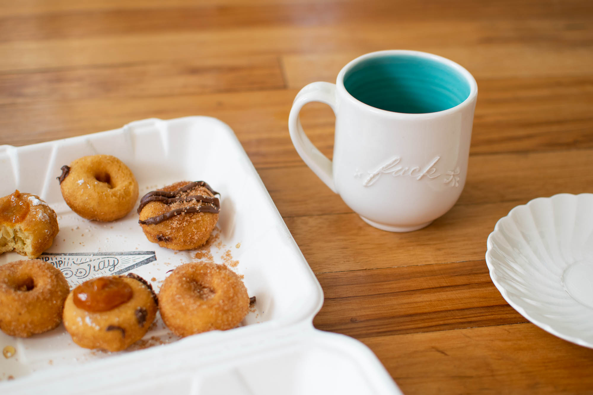 Cute little donuts from Pip's and a mug that reads "fuck" in cursive.