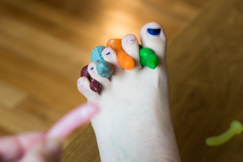 Tiny dildo mock-up photo of them acting as toe separators during a pedicure.