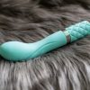 BMS Factory Pillow Talk Sassy rechargeable G-spot vibrator lying on some soft grey fur.