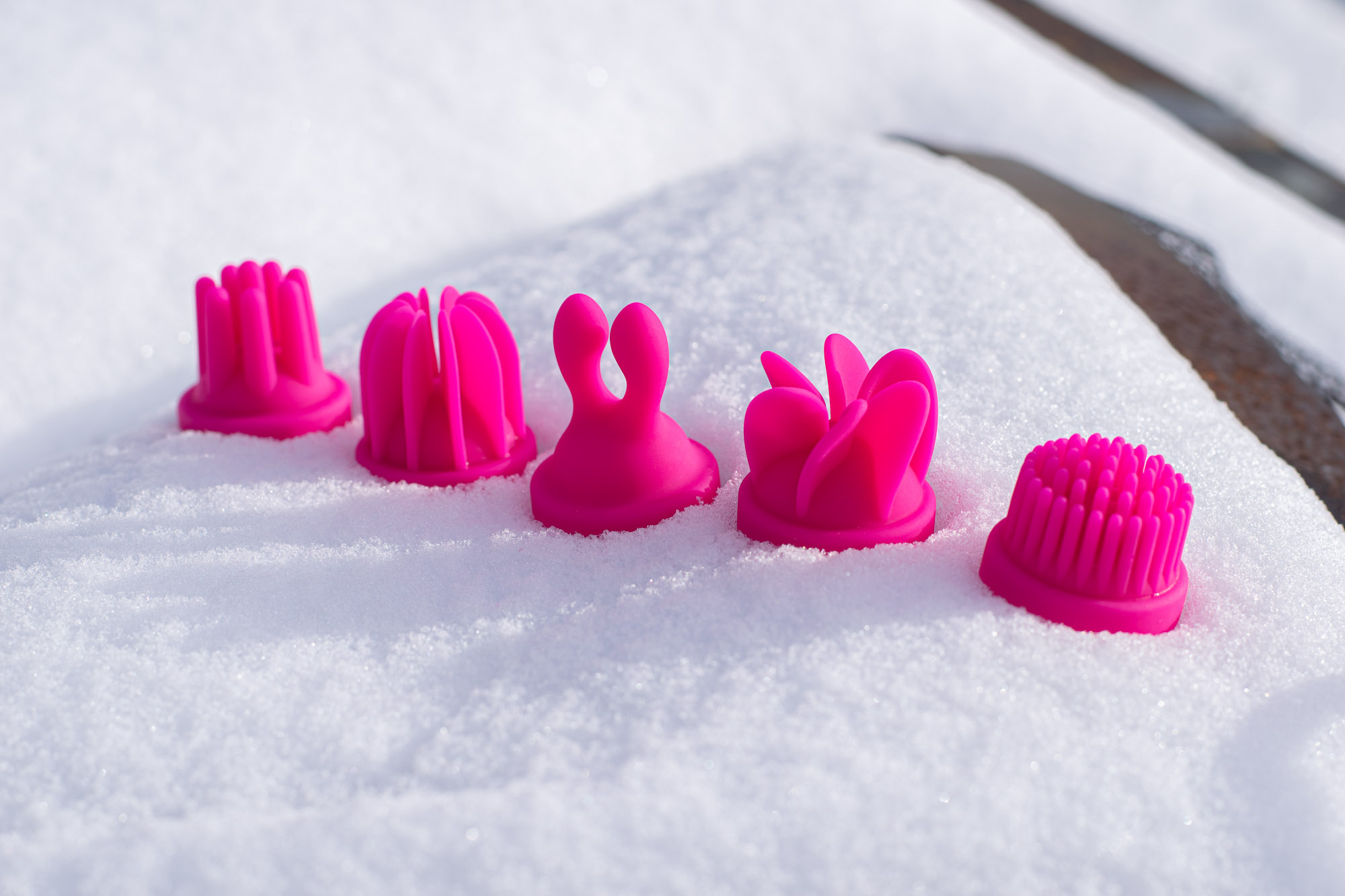 Attachments for the Adrien Lastic Caress lying on a snow bank.