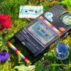 Sex blogger field notes: audio journal. Cassette player lying in the grass, surrounded by sex toys and Epiphora-labeled cassette tapes.