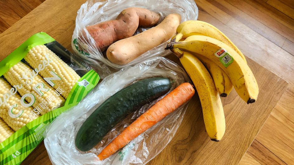 All the fruits and veg I bought: corn, yam, cucumber, carrot, and bunch of bananas.